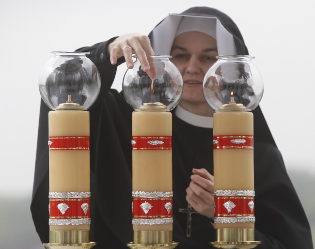Sister Sancja readies the altar in GodÂs Mercy sanctuary in Krakow, Poland