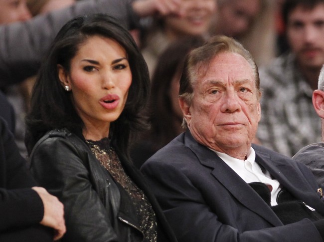 Los Angeles Clippers owner Donald Sterling, right, and V. Stiviano, left, watch the Clippers play the Los Angeles Lakers during an NBA preseason basketball game in Los Angeles on Monday, Dec. 19, 2010.