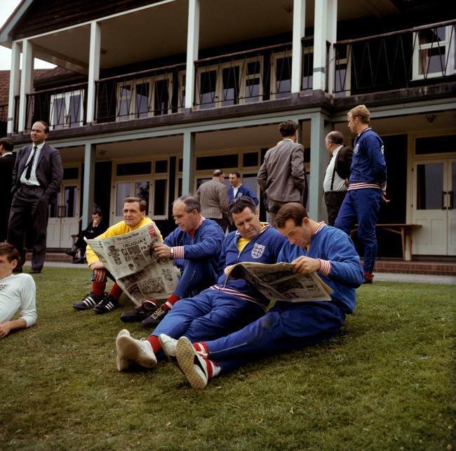 (L-R) England trainer Les Cocker, manager Alf Ramsey, physio Harold Shepherdson and Jimmy Greaves read the morning newspapers during a relaxing training session at Roehampton Ref #: PA.2219402  Date: 15/07/1966