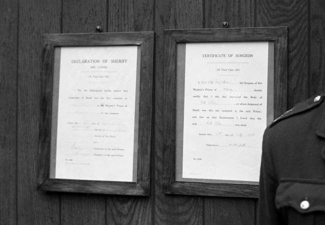The notices of Sheriff and Surgeon, announcing the execution of Mrs Ruth Ellis, are posted on the gates of Holloway Prison.