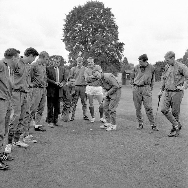 England's Jimmy Greaves (third r) lines up a putt as he and his teammates take a break from the serious business of preparing for the World Cup Final. Looking on are (l-r) trainer Les Cocker, Peter Bonetti, Bobby Moore, ?, Jimmy Armfield, Roger Hunt, Ron Springett, Norman Hunter and Ron Flowers Ref #: PA.2494092  Date: 29/07/1966