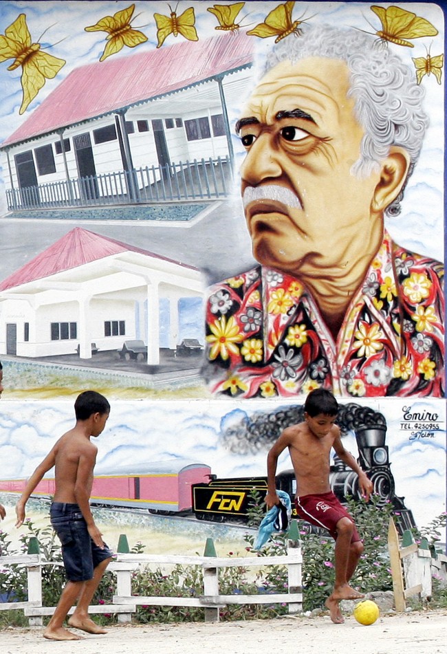 Two boys play soccer in front a mural painting of Nobel Prize-winner Gabriel Garcia Marquez in Aracataca, Colombia, Jan. 4,2006.