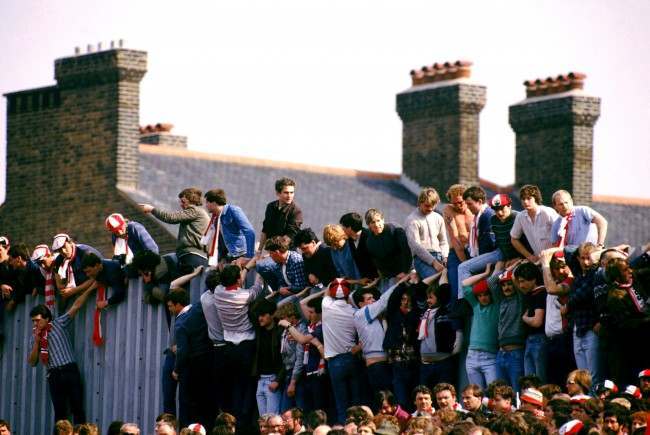 Southampton fans sit on a wall to get the best view at Highbury 