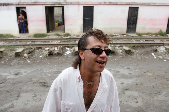 A client talks with other men, unseen, before paying for the services of a prostitute on a street called in Spanish "La Linea," or "The Strip," where dozens of women work as prostitutes in Guatemala City, Monday, May 28, 2007. (AP Photo/Alexandre Meneghini)