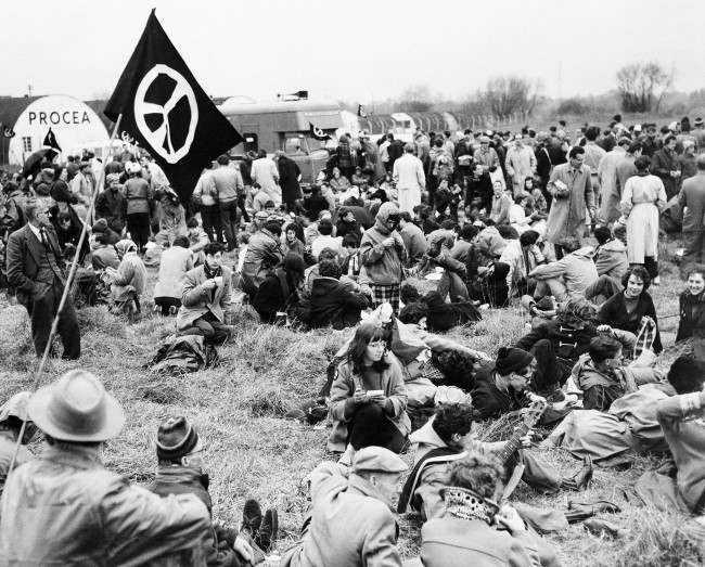 Marchers protesting nuclear bomb tests rest in a field near airport in London March 30, 1959. 