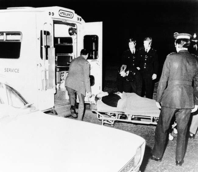 A wounded man is carried into the waiting ambulance on March 20, 1974 in London in the mall the approach road to Buckingham Palace after shots had been fired at Princess Anne and her husband, Mark Phillips, as they drove in their Rolls Royce toward the palace. Also involved in the shooting was a London taxi which was following the Royal Car at the time. Princess AnneÂs bodyguard, her chauffer and a man in the taxi were hit by the gunmen. The Princess and husband escaped unharmed. (AP Photo) Ref #: PA.7090585  Date: 20/03/1974