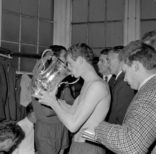 Liverpool's Wilf Stevenson drinks from the FA Cup in the dressing room after his team's 2-1 win