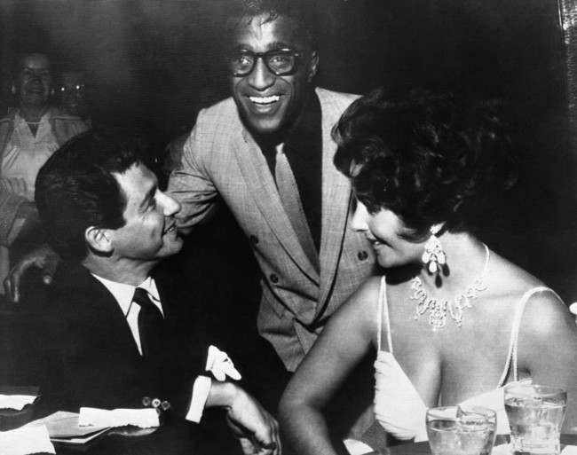Elizabeth Taylor, right, and Eddie Fisher, left, discuss wedding plans with Sammy Davis, Jr. shortly before dawn at the Hotel Tropicana, April 2, 1959, Las Vegas, Nev. The actress and Fisher said where they will marry depends on what Debbie Reynolds Fishers ex-wife, says. If Miss Reynolds agrees to a quickie Nevada divorce, Liz and Eddie will wed here, otherwise Mexico. 