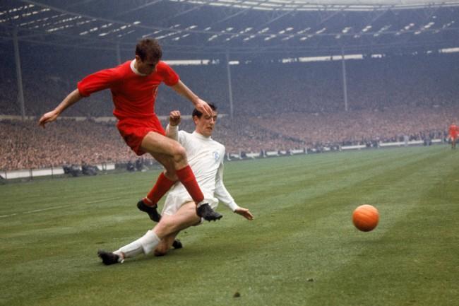 Leeds United's Norman Hunter (r) slides in too late to prevent Liverpool's Roger Hunt (l) firing the ball across