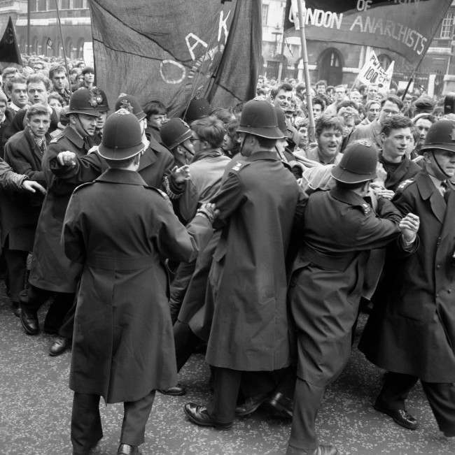 Police straining against a solid mass of people in an effort to control a contingent of Aldermaston to London marchers as they made their way to the final rally in Hyde Park. Ref #: PA.8520327  Date: 15/04/1963