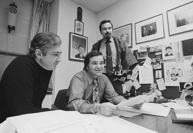  In this 1972 file photo, "Mad" magazine Editor Al Feldstein, center, sits with Art Director John Putnam, left, and a freelancer named Jack, at the magazine's New York headquarters. Feldstein, whose 28 years at the helm of Mad transformed the satirical magazine into a pop culture institution, died Tuesday, April 29, 2014. He was 88. (AP Photo/Jerry Mosey, File)