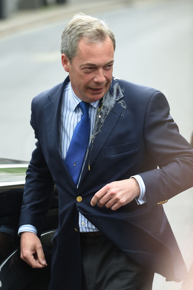 UKIP leader Nigel Farage is hit by an egg as he gets out of his car in Nottingham city centre. Picture date: Thursday May 1, 2014.