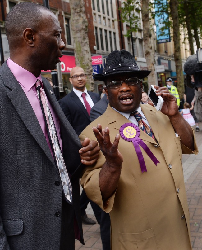 UKIP candidate for Croydon Winston McKenzie speaks to his leader Nigel Farage on the phone in Croydon town centre where was due to speak, but didn't turn up.