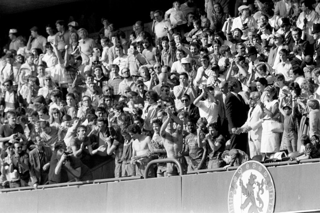 Soccer - Football League Division Two - Chelsea v Leeds United - Stamford Bridge (L-R) Chelsea's Joey Jones, Colin Lee, Joey McLaughlin, Kerry Dixon, Paul Canoville and Mickey Thomas salute the fans from the front row of the directors' box after their 5-0 win secured promotion to the first division Date: 28/04/1984