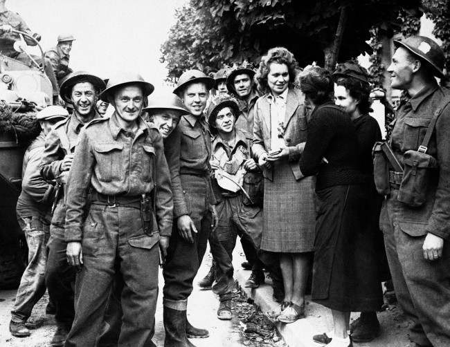 French girls give a hearty welcome to Canadian troops passing thru a town in the Normandy coast area of France on Oct. 6, 1944 after Allied assault forces had driven back the Germans. (AP Photo)