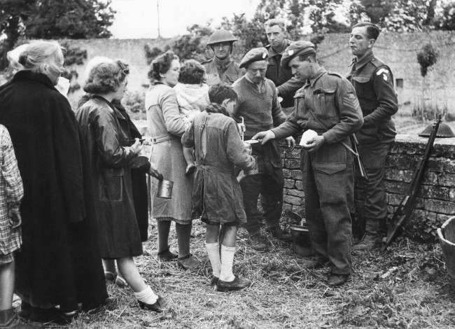 Many of the French refugees had not eaten for three or more days. They are seen receiving food from British troops in France on June 12, 1944. The feeding arrangements were organized by the Civil Affairs Department. (AP Photo) 