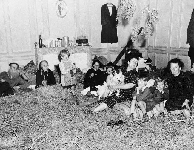 Old and young, these refugees from the French town of St. Lo, in Normandy on July 30, 1944, take up temporary quarters in a former mansion following their return to the newly liberated town. Straw has been placed on the floor to provide a little comfort in the house that are being cared for by Allied Civil affairs authorities. (**Caption information received incomplete) (AP Photo)