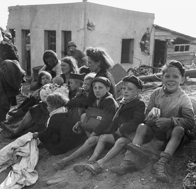 French civilian refugees who sought refuge in a beachhead area in Normandy on June 10, 1944. (AP Photo) Ref #: PA.10847265  Date: 10/06/1944 