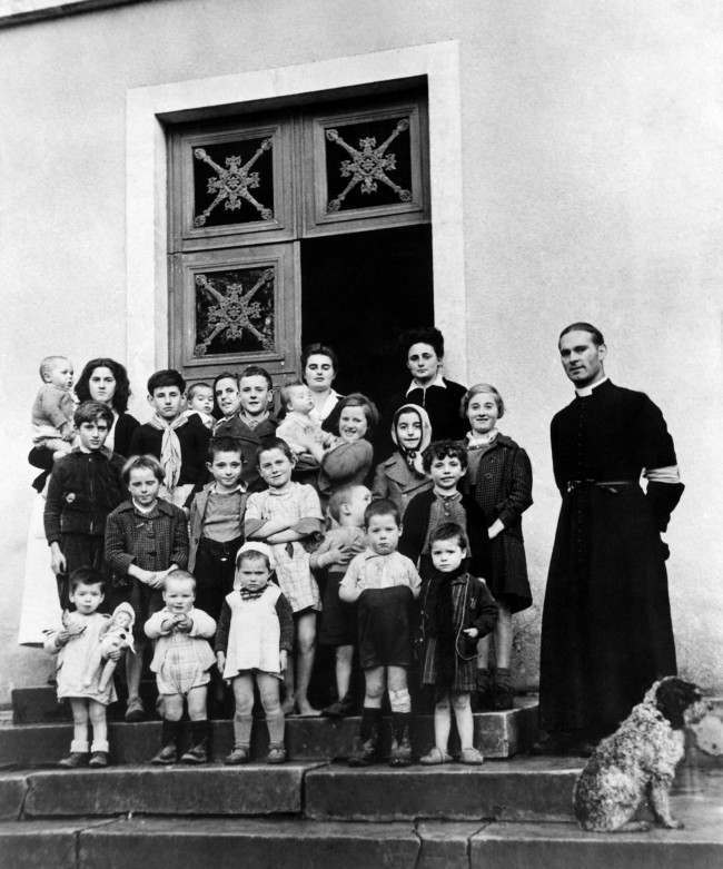 French war orphans Âsomewhere in NormandyÂ with Abbe Noe, Parish priest, at the new French colony opened by the Foster Parents plan for war children on Dec. 11, 1944. The children had one blanket for all and were living on a diet of coffee and stale bread when they were found by Lieut. Bishop Marshall, plan representative in France. (AP Photo)