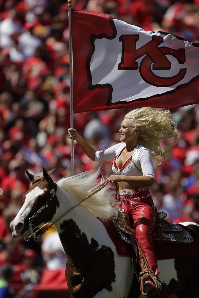 A Kansas City Chiefs Cheerleader rides Chiefs' mascot Warpaint during the first half of an NFL football game against the Atlanta Falcons Sunday, Sept. 9, 2012, in Kansas City, Mo.