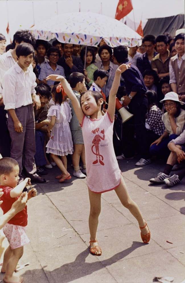 A young Chinese girl dances on Tiananmen Square about June 1, 1989, as pro-democracy protesters continued to occupy the square. Hundreds were killed a few days later in violent clashes between the demonstrators and government troops. (AP Photo/Jeff Widener) Ref #: PA.19962918  Date: 01/06/1989