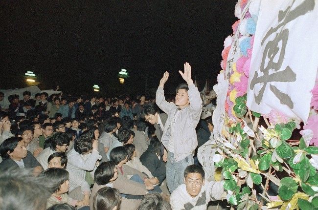 A student leader tries in vain to settle down a crowd of Beijing University students who converged on the Chinese Communist Party headquarters at Zhongnanhai early on Wednesday, April 19, 1989 in Beijing after demonstrating in Tiananmen Square all day on Tuesday. The students later tried to storm the gate, but were fought by Chinese security. (AP Photo/Mark Avery)