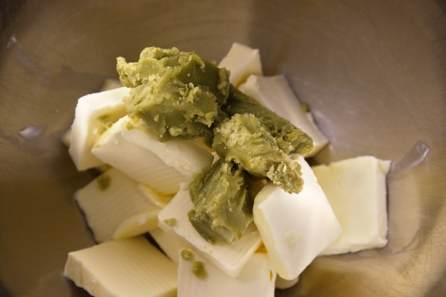  Green cannabis-infused "canna butter" is placed with regular butter in a stainless steel mixer at the start of batter mixin