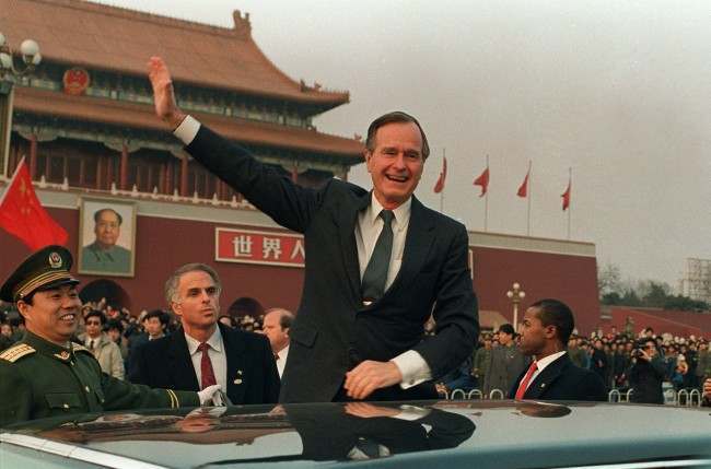 President Bush stands on his car and waves in Tiananmen Square in Beijing during a visit to China in this Feb. 25, 1989 photo. On the wall in the background is a portrait of Mao Tse-tung at the entrance to the Forbidden City. Now that the elder Bush's son is about to become President George W. Bush, the Chinese are uneasy. While campaigning, George W. Bush and his foreign policy advisers asserted U.S. interests in ways China finds threatening. (AP Photo/Doug Mills, File)