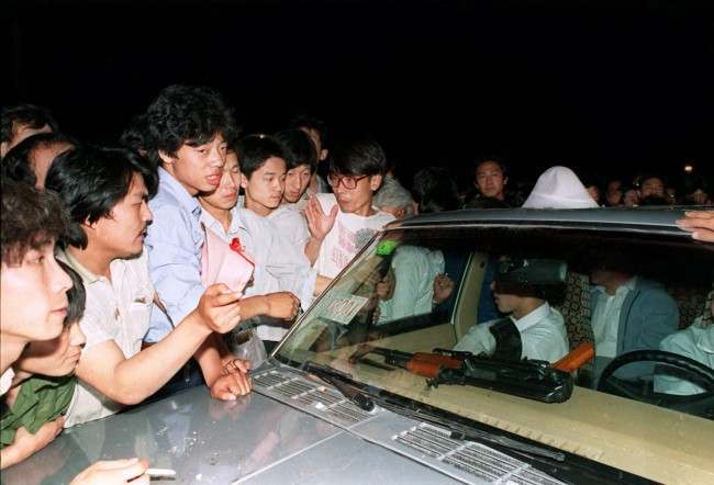 Beijing residents ask soldiers what they were going to do with the machine gun on their dashboard as they surround and stop a carload of chinese soldiers on their way towards to Tiananmen Square in this June 3, 1989 photo. Friday June 4, 1999 is the 10th anniversary of the military assault on pro-democracy protesters who had occupied the square for seven weeks. Hundreds died in the early hours of June 4, 1989 when troops shot their way through Beijing's streets to retake the square. (AP Photo/Mark Avery, File)