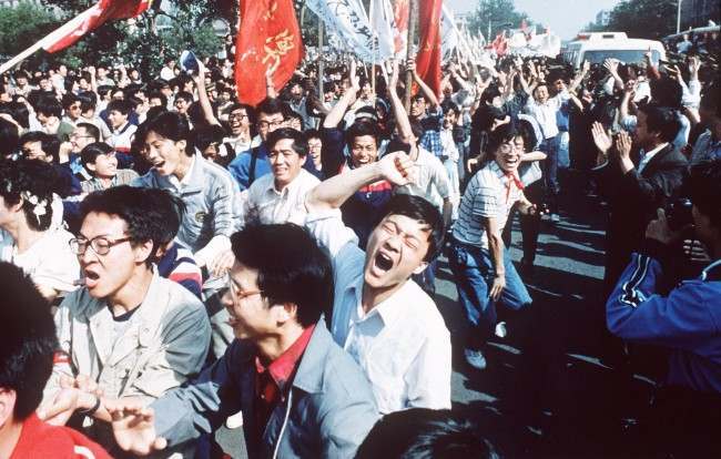 Chinese students shout after breaking through a police blockade during a pro-democracy march to Tiananmen Square, Bejing, May 4 1989. (AP Photo/S. Mikami)