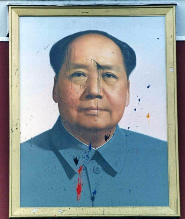 The famous portrait of Chairman Mao looking out over Tiananmen Square, Beijing, from the Forbidden City, May 23, 1989, was spattered with paint during the continuing demonstration in the square. (AP Photo/Avery) 