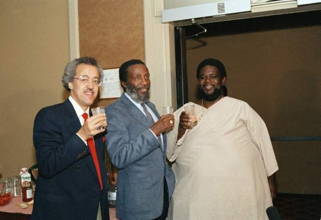 Ron High, who has lost 300 pounds but he says he can?t see the difference, joins comedian Dick Gregory, left, at a news conference in New York, May 6, 1986. High has lived at Gregory's International Health Institute in the Bahamas, constantly monitored as he eats fruits and vegetables and Gregory's diet potion in addition to exercising. High of Brooklyn, New York said "I?m learning about my body." (AP Photo/Susan Ragan)