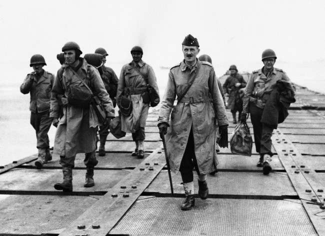 French General Philippe Le Clerc, carrying walking stick, shown walking down a pier somewhere in Normandy, France, on Aug. 2, 1944, after his arrival. This is his first visit to France in four years. (AP Photo)