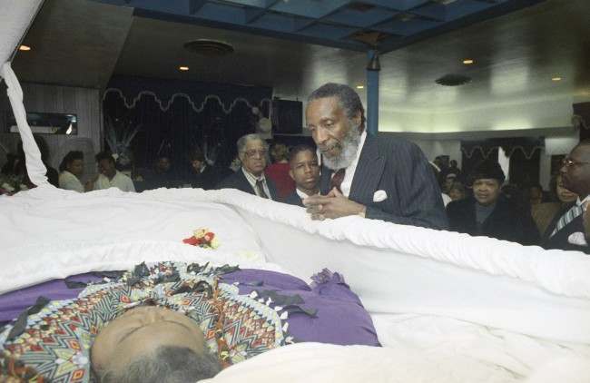 Nutrition guru Dick Gregory, right, pays his respects at the funeral of Walter Hudson, who weighed over 1,000 pounds when he died Christmas Eve in Hempstead, New York, Jan. 2, 1992. Hudson had at one point lost more than 600 pounds with the help of Gregory. (AP Photo/Mike Albans)