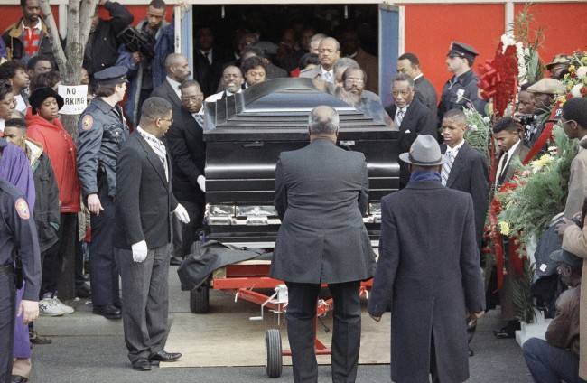 Eight pallbearers roll the custom-made casket of Walter Hudson, who weight more then 1,000 pounds when he died, on a metal dolly out of Gospel Blessed Center Church in Hempstead, New York, after funeral services, Jan. 3, 1992. Hudson, who died Christmas Eve of a heart attack, attracted worldwide attention when he lost over 600 pounds several years ago with the help of nutrition guru Dick Gregory. (AP Photo/Mike Albans)