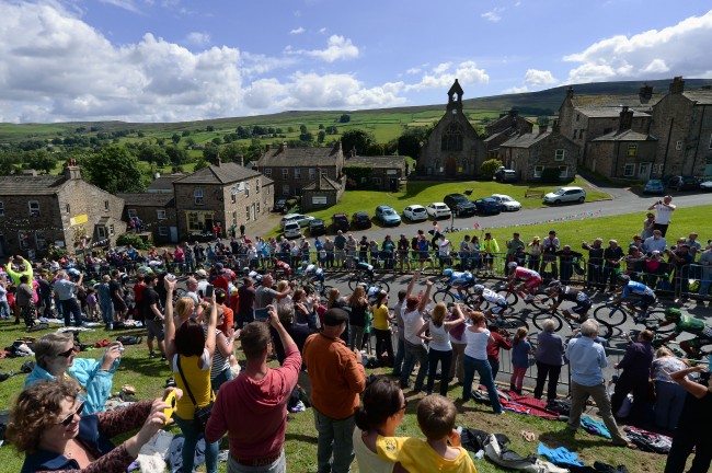 The Peloton passes through the village of Reeth, Yorkshire during the 2014 Tour de France.