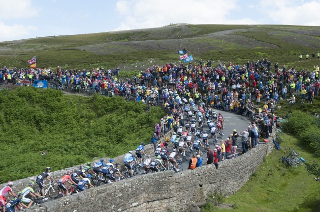 The peloton rides over a bridge on Grinton Moor as stage one of the Tour de France passes over the Grinton Moor, Yorkshire.