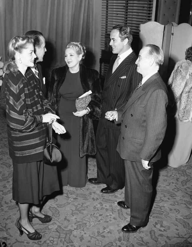 Left to right are actress Lauren Bacall, Humphrey Bogart, Mary Pickford, Buddy Rogers, and Raymond McCall of the New York Times, at Associated Press managing editors dinner at Los Angeles Biltmore Bowl on Nov. 29, 1946. 