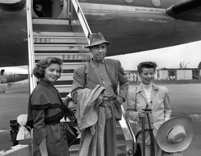 Actor Humphrey Bogart, his actress wife Lauren Bacall (L) and actress Katharine Hepburn at London Airport, after arriving in the UK from Africa after filming. 1951