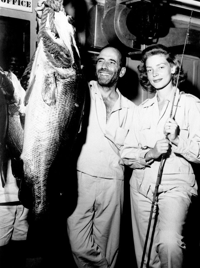 American actor Humphrey Bogart and his actress wife Lauren Bacall with a Nile Perch, which he caught while on location in Africa for exterior scenes in his new film 'The African Queen'. Date: 01/09/1951