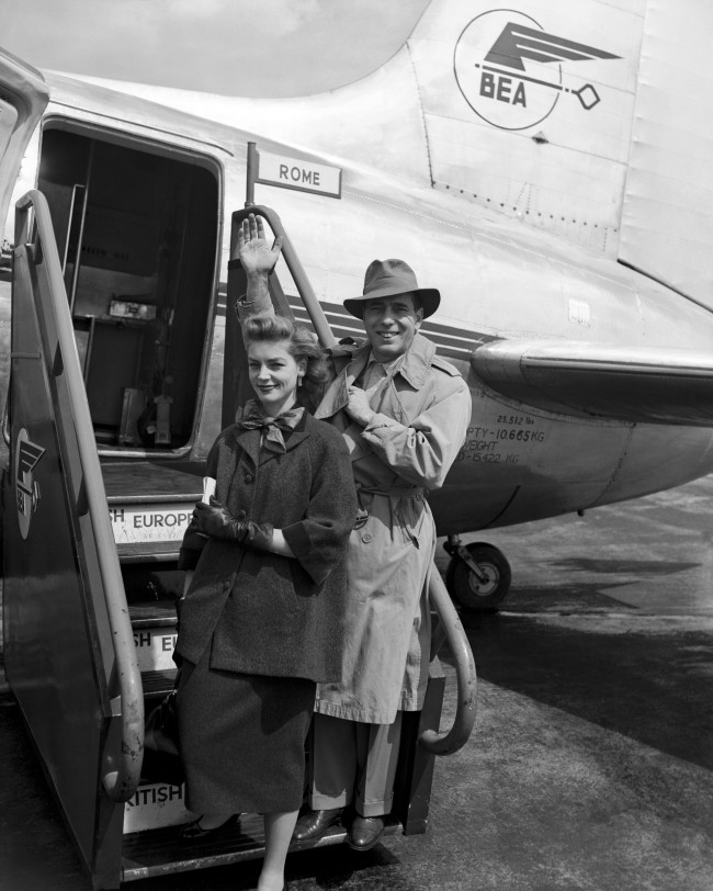 American actors Humphrey Bogart and his wife Lauren Bacall, board a BEA Viking for Rome at Heathrow Airport. 1951.