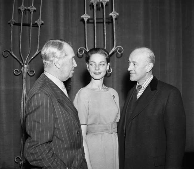 Maurice Chevalier (left) talks to Lauren Bacall and Alec Guinness at the rehearsal for the Royal Film Performance at the Empire Theatre in Leicester Square, London. Date: 01/02/1959 