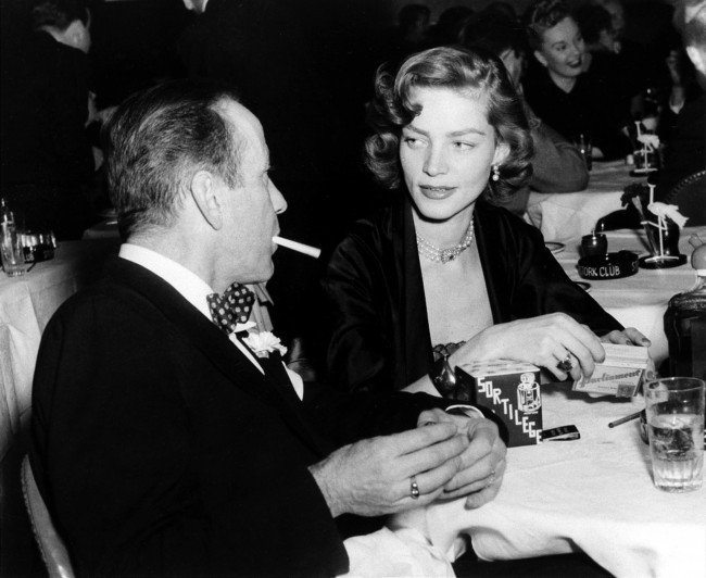 This Feb. 1950 file photo shows actor Humphrey Bogart, left, and his wife actress Lauren Bacall appear at the Stork Club in New York. Bacall, the sultry-voiced actress and Humphrey Bogart's partner off and on the screen