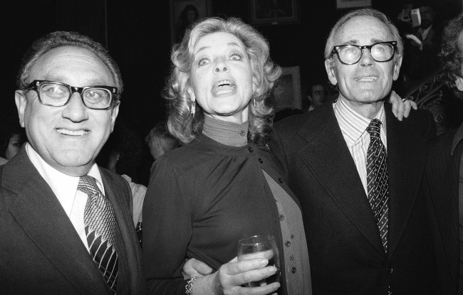 This June 8, 1979 file photo shows actress Lauren Bacall, center, with Henry Kissinger, left, and actor Henry Fonda at a party to launch her autobiography,"By Myself" at the Palace Theater in New York.