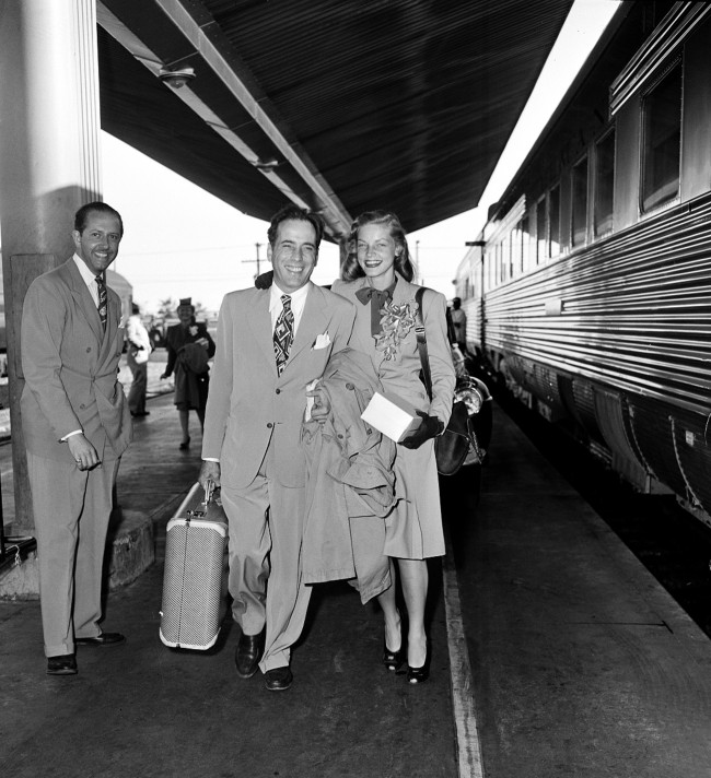 Actor Humphrey Bogart and actress Lauren Bacall are shown at a train station before they board the Santa Fe in Los Angeles, Ca., on May 18, 1945. The couple will travel to Mansfield, Ohio, where they will get married at a friend's farm. 