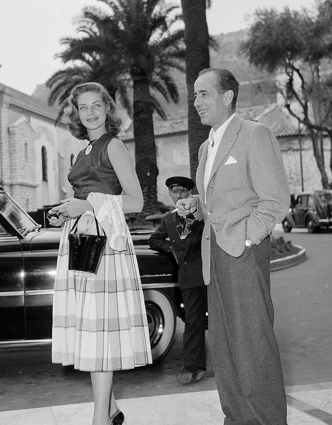 Actress Lauren Bacall, left, and her husband, actor Humphrey Bogart, are shown on a street in Cannes during a few days vacation on the French Riviera, France, on June 26, 1953. (AP Photo)