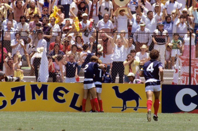 Soccer - World Cup Mexico 1986 - Group E - Scotland v West Germany - La Corregidora Stadium (L-R) Scotland's Richard Gough congratulates teammate Gordon Strachan on scoring the opening goal as Graeme Souness runs to join them Date: 08/06/1986