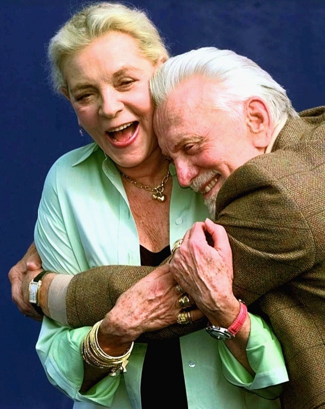 American movie stars Lauren Bacall and Kirk Douglas hug during a photocall to promote their movie "Diamonds" by U.S. director John Asher to be screened at the American Film Festival in Deauville, Normandy, France, Tuesday, Sept. 7, 1999. 