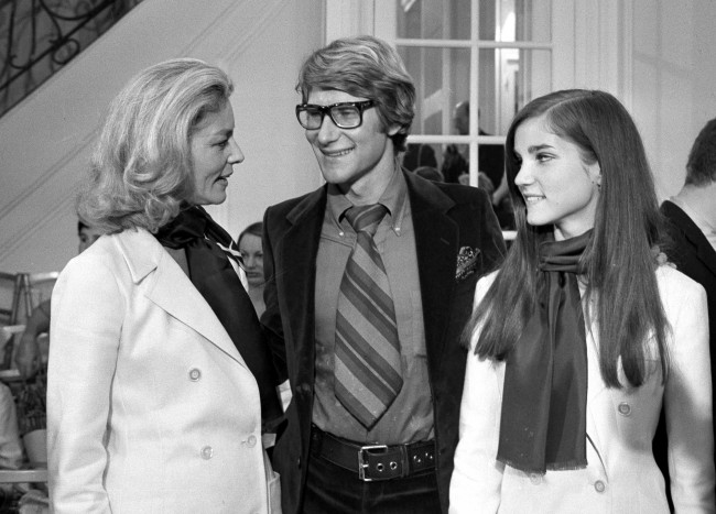 French designer Yves Saint Laurent, center, is congratulated by American actress Lauren Bacall, left, and her daughter Leslie Bogart, after the presentation of Saint Laurent's fashion collection. 1968.