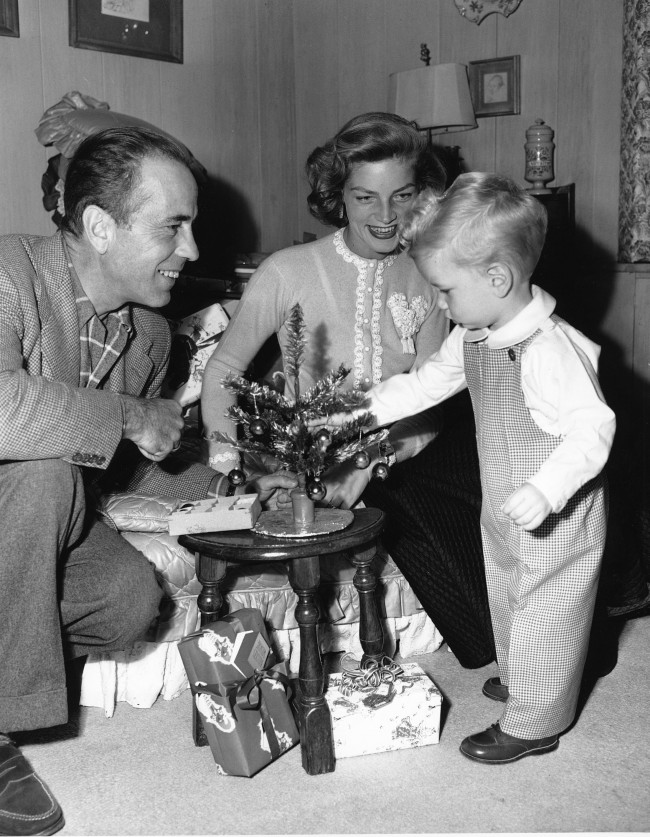 Actor Humphrey Bogart and his wife, actress Lauren Bacall, help their son Stephen decorate a small Christmas tree in their home in Hollywood, Calif., on Dec. 20, 1950. 